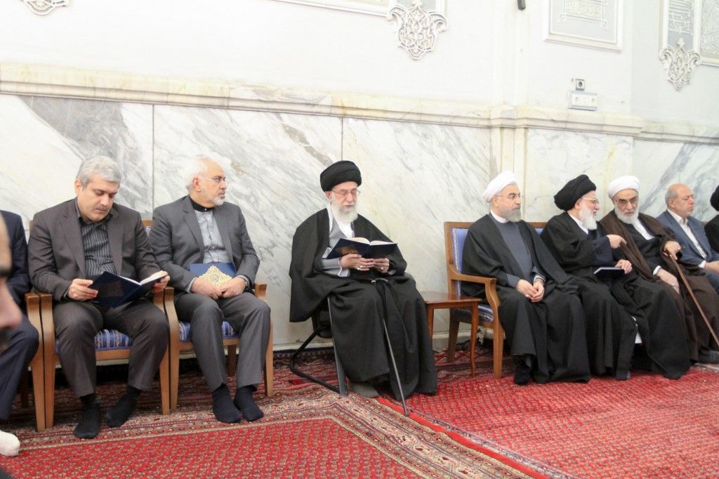 Iran's Supreme Leader Ali Khamenei in the funeral ceremony held for the then-president Hassan Rouhani's mother, along with Javad Zarif and  Sorena Sattari to his right, and Hassan Rouhani, Ayatollah Shahroudi, Ayatollah Mohammadi-Golpayegani to his left in Tehran, Iran, on March 25, 2025. (Photo by Mohammadali Najib / Middle East Images via AFP)