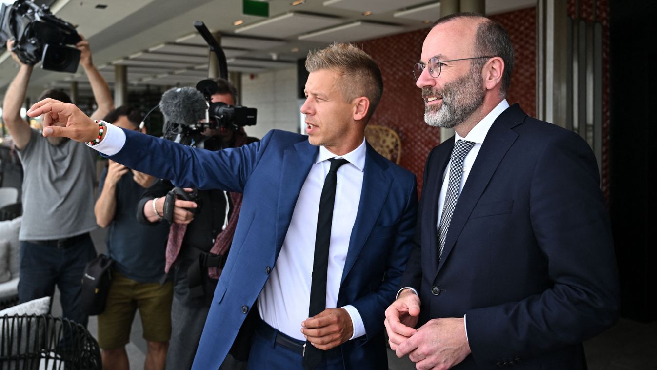 leader of Hungarian Tisza party and former government member turned opposition leader Peter Magyar gestures (R) as President of the centre-right European People's Party (EPP) Manfred Weber looks on during a meeting on top of a Budapest's hotel in Hungary 