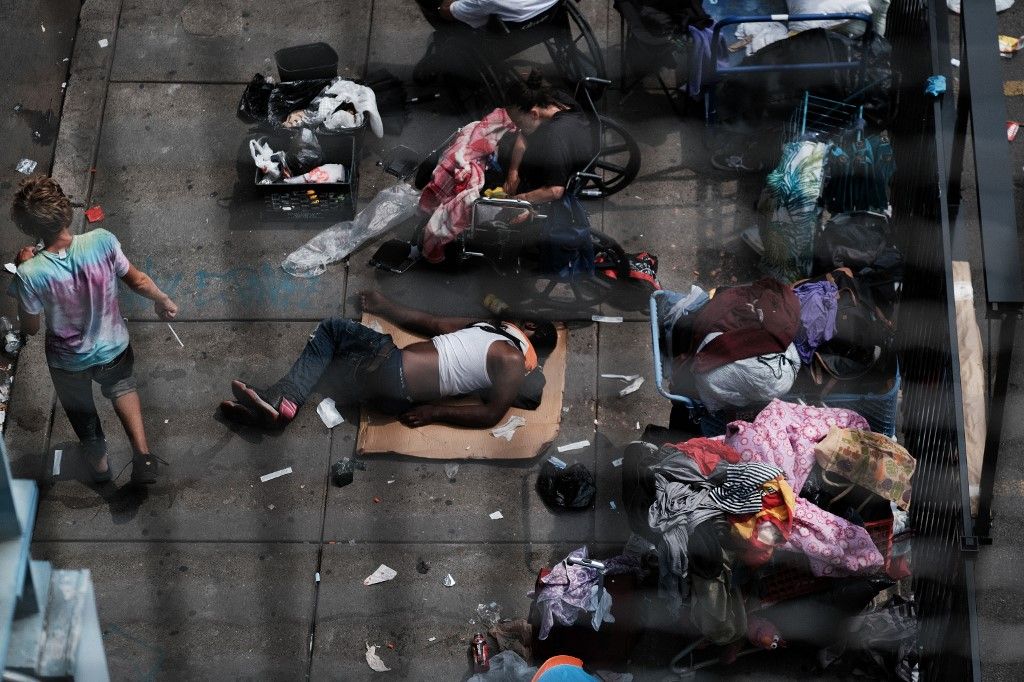 PHILADELPHIA, PENNSYLVANIA - JULY 19: People gather on a street overtaken by heroin users in Kensington on July 19, 2021 in Philadelphia, Pennsylvania. According to data from the US Centers for Disease Control and Prevention's National Center for Health Statistics, over 93,000 people died from a drug overdose last year in America. These numbers and the continued rise in opioid use made 2020 the deadliest year on record for drug overdoses. Officials have said that the increase is being driven by the lethal prevalence of fentanyl and stressed Americans due to the Covid pandemic. Kensington, a neighborhood in Philadelphia, has become one of the largest open-air heroin markets in the United States.   Spencer Platt/Getty Images/AFP (Photo by SPENCER PLATT / GETTY IMAGES NORTH AMERICA / Getty Images via AFP)
