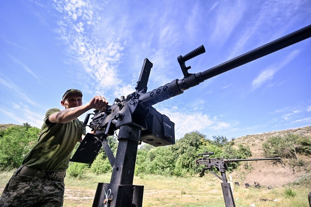 A fighter of the Separate Anti-Aircraft Machine Gun Battalion, who is providing air cover for the unmanned aerial vehicles and destroying targets at a distance of up to 1,500 meters, is practicing shooting from a Browning heavy machine gun in Zaporizhzhia region, southeastern Ukraine, on July 10, 2024. NO USE RUSSIA. NO USE BELARUS. (Photo by Ukrinform/NurPhoto) (Photo by Dmytro Smolienko / NurPhoto via AFP)