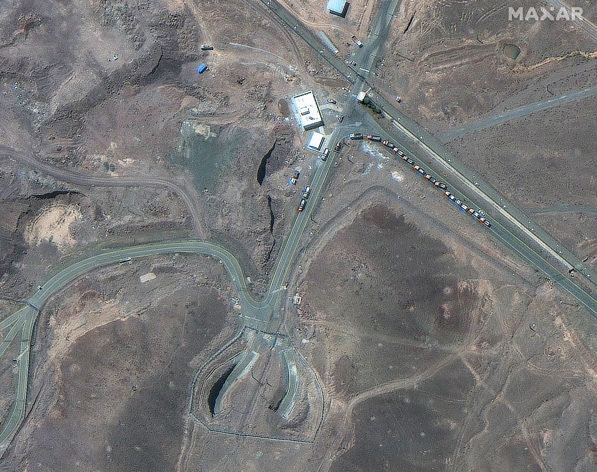 This handout satellite image courtesy of Maxar Technologies shows cargo trucks postioned near an underground entrance to Iran's Fordow Fuel Enrichment Plant (FFEP), in Fordo, Iran on June 19, 2025. President Donald Trump on June 21, 2025 warned Iran to not respond after US strikes targeted its main nuclear enrichment facilities in attacks he called a "spectacular military success." President Donald Trump said June 21, 2025 the US military has carried out a "very successful attack" on three Iranian nuclear sites, including the underground uranium enrichment facility at Fordo. "We have completed our very successful attack on the three Nuclear sites in Iran, including Fordow, Natanz, and Esfahan," Trump said in a post on his Truth Social platform. (Photo by Satellite image ©2025 Maxar Technologies / AFP) / RESTRICTED TO EDITORIAL USE - MANDATORY CREDIT "AFP PHOTO / Satellite image ©2025 Maxar Technologies" - NO MARKETING NO ADVERTISING CAMPAIGNS - DISTRIBUTED AS A SERVICE TO CLIENTS