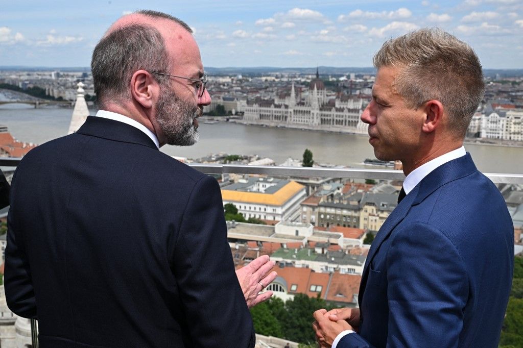 President of the centre-right European People's Party (EPP) Manfred Weber  (L) and leader of Hungarian Tisza party and former government member turned opposition leader Peter Magyar are pictured during a meeting on top of a Budapest's hotel in Hungary on June 14, 2024. Weber arrived to Budapest about the accession of the seven elected members of the European Parliament of the Tisza party. (Photo by Attila KISBENEDEK / AFP)