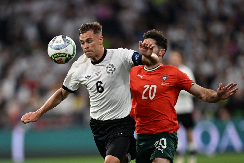 MUNICH, GERMANY - JUNE 04: Joshua Kimmich (6) of Germany in action against Pedro Neto (20) of Portugal during the UEFA Nations League 2025 semi-final match between Germany and Portugal at the Allianz Arena Stadium on June 4, 2025, Munich, Germany. Halil Sagirkaya / Anadolu (Photo by HALIL SAGIRKAYA / Anadolu via AFP)