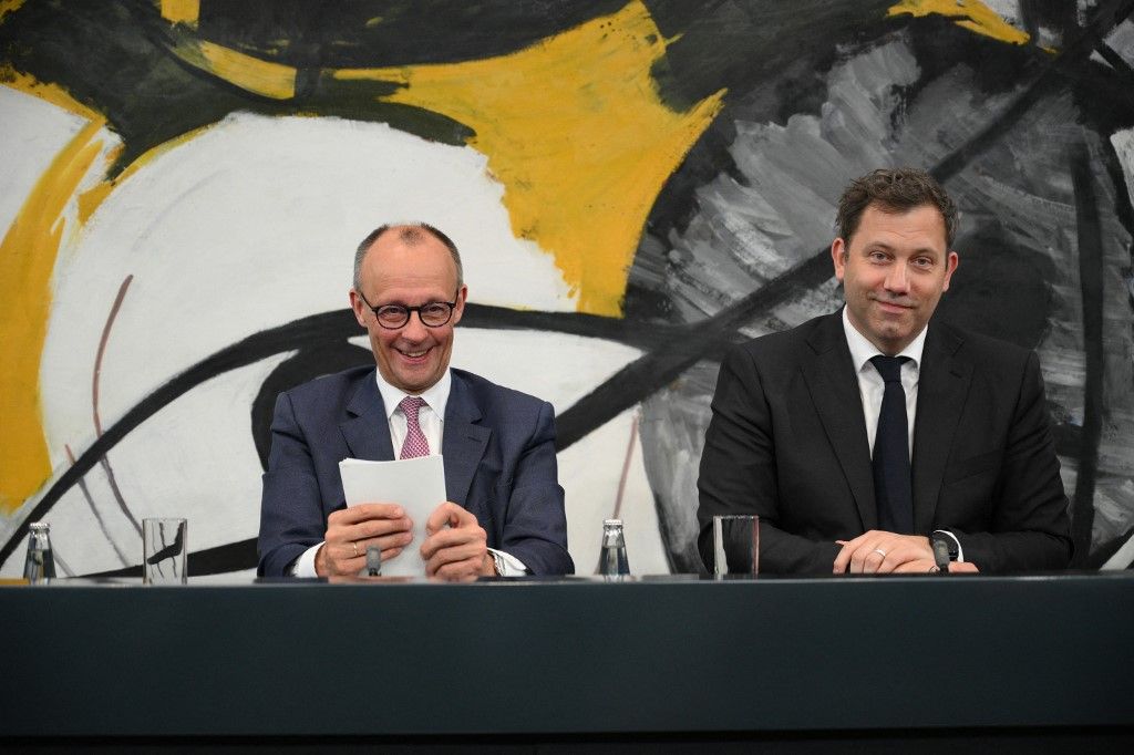 German Chancellor Friedrich Merz (L) and German Finance Minister and Vice Chancellor Lars Klingbeil react during a joint press conference with Bavaria's State Premier and leader of the conservative Christian Social Union (CSU) and Germany's Social Democratic Party (SPD) co-leader after the first meeting of the Coalition committee of the govenment's parties CDU, CSU and SPD, in Berlin on May 28, 2025. (Photo by RALF HIRSCHBERGER / AFP)