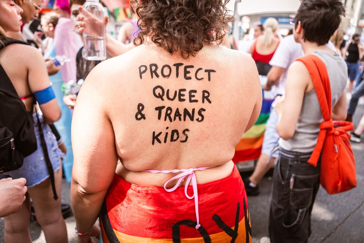 A person wrote PROTECT QUEER AND TRANS KIDS on their back during the pride march on June 14 2025 in Lyon France. (Photo by Elsa Biyick / Hans Lucas via AFP)