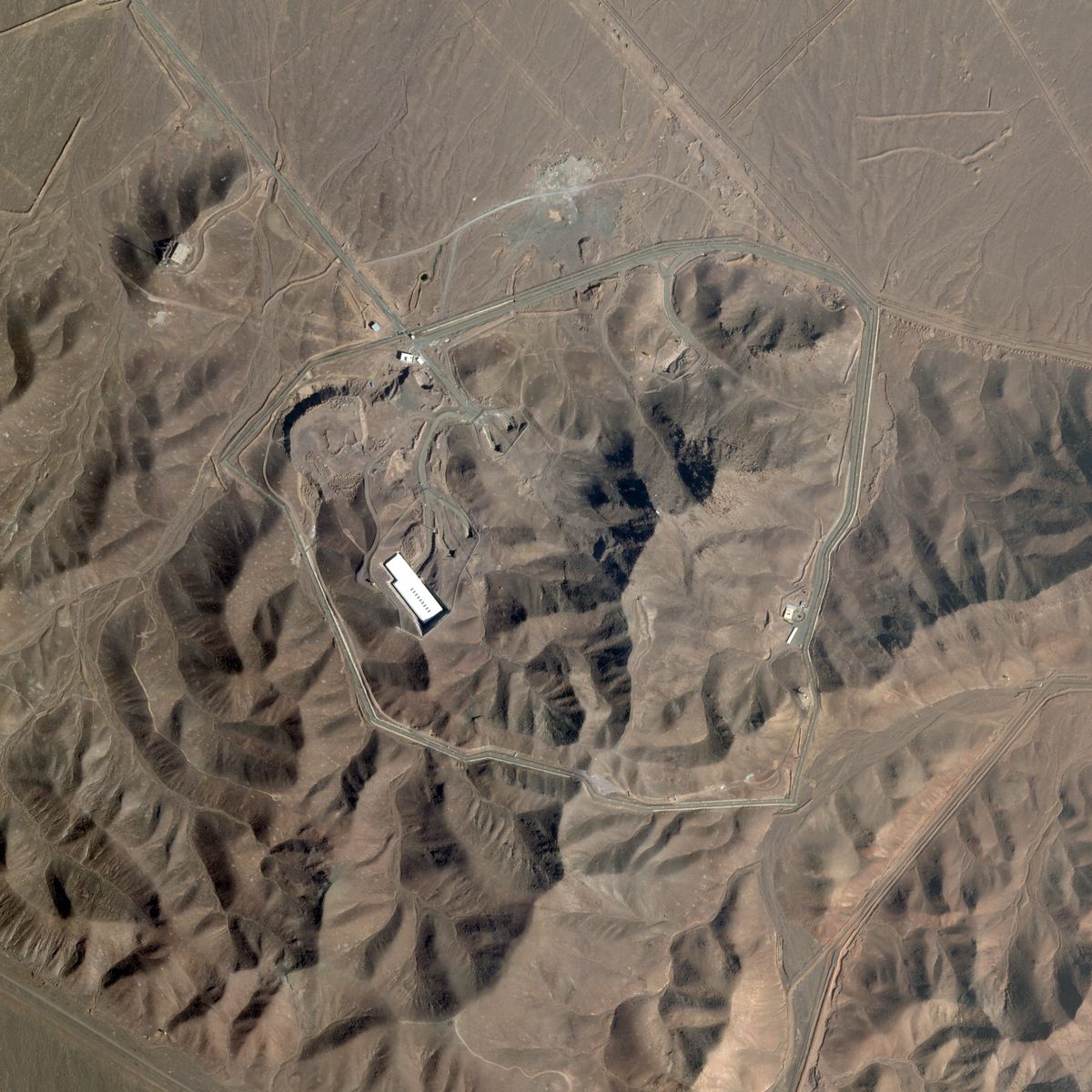 (FILES) This handout satellite image released by Planet Labs on June 13, 2025, shows the Fordow Fuel Enrichment Plant, northeast of Qom, Iran on May 19, 2025. President Donald Trump said June 21, 2025 the US military has carried out a "very successful attack" on three Iranian nuclear sites, including the underground uranium enrichment facility at Fordo. "We have completed our very successful attack on the three Nuclear sites in Iran, including Fordow, Natanz, and Esfahan," Trump said in a post on his Truth Social platform. He was set to address the nation at 10 pm (0200 GMT) after deciding to join Israel's strikes on Iran's nuclear program. (Photo by Handout / © 2025 PLANET LABS PBC / AFP) / RESTRICTED TO EDITORIAL USE - MANDATORY CREDIT "AFP PHOTO / © 2025 PLANET LABS PBC" - NO MARKETING NO ADVERTISING CAMPAIGNS - DISTRIBUTED AS A SERVICE TO CLIENTS - Existing watermarks may not be removed/cropped