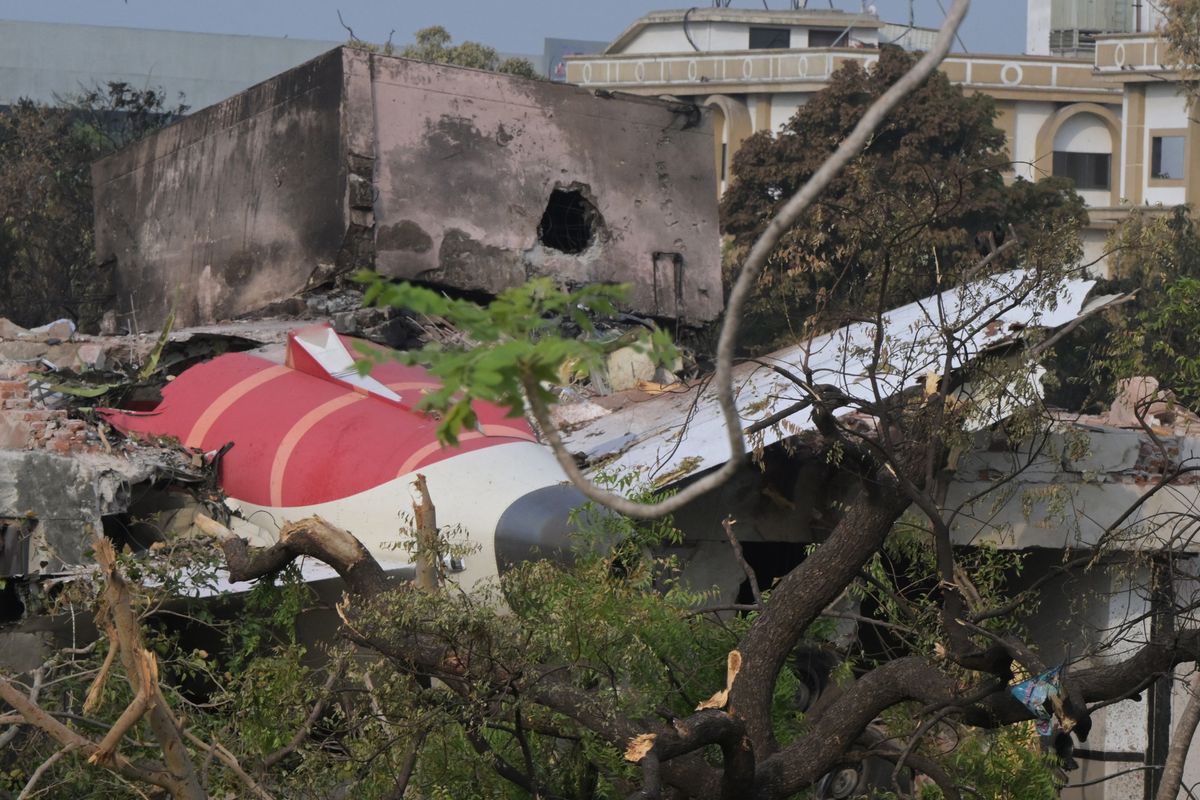 Wreckage showing the tail section of the Air India Boeing 787-8 is pictured in a residential area near the airport in Ahmedabad on June 14, 2025, after the aircraft operating as flight 171 crashed shortly after taking off on June 12. Investigators recovered a black box recorder on June 13 from the crash site of a London-bound passenger jet that ploughed into a residential area of India's Ahmedabad city, killing at least 265 people on board and on the ground. (Photo by DIBYANGSHU SARKAR / AFP)