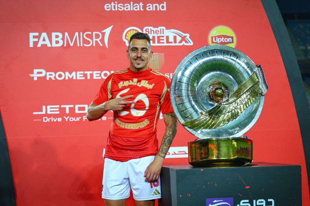 Nejc Gradisar Al Ahly striker celebrates with The League trophy after winning the Egyptian Premier League after the match between Al Ahly FC vs Pharco FC in the Last round of the final stage of the Egyptian Premier League (Nile League) at Cairo Stadium on May 28, 2025. (Photo by Mohamed Tageldin / Middle East Images via AFP)