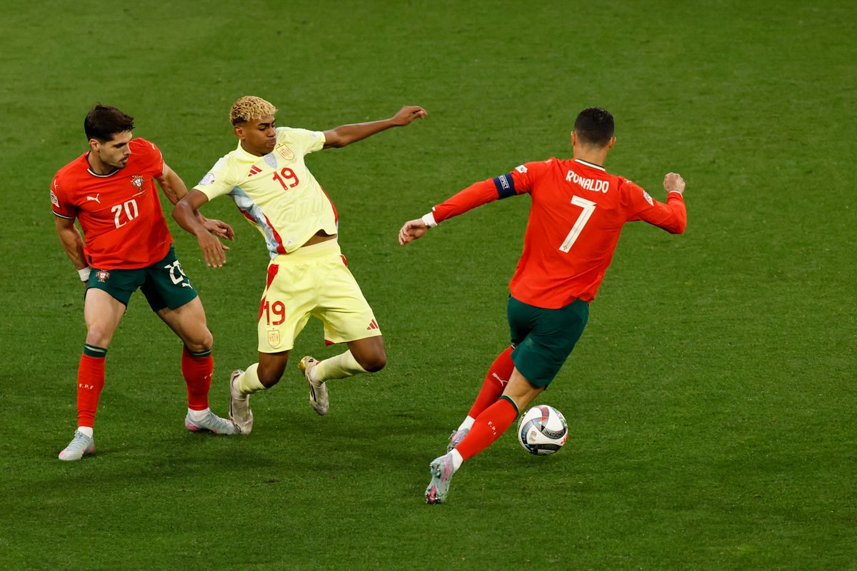 (L-R) Portugal's forward #20 Pedro Neto, Spain's forward #19 Lamine Yamal and Portugal's forward #07 Cristiano Ronaldo vie for the ball during the UEFA Nations League final football match between Portugal and Spain in Munich, southern Germany on June 8, 2025. (Photo by Alexandra BEIER / AFP)