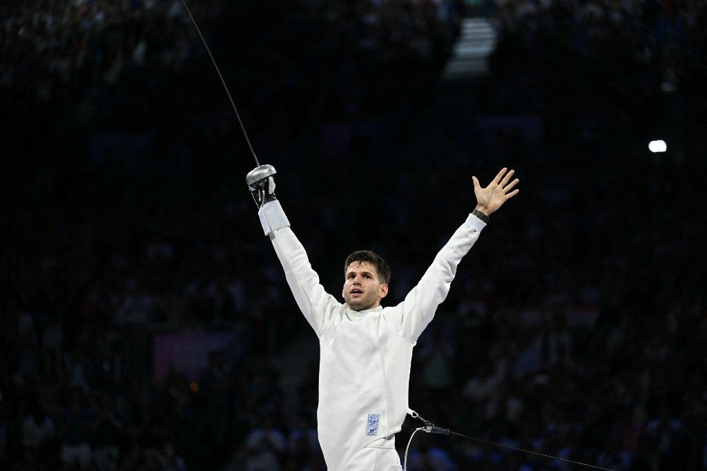 Hungary's Gergely Siklosi celebrates after winning in the men's epee team gold medal bout between Japan and Hungary during the Paris 2024 Olympic Games at the Grand Palais in Paris, on August 2, 2024. (Photo by Fabrice COFFRINI / AFP)