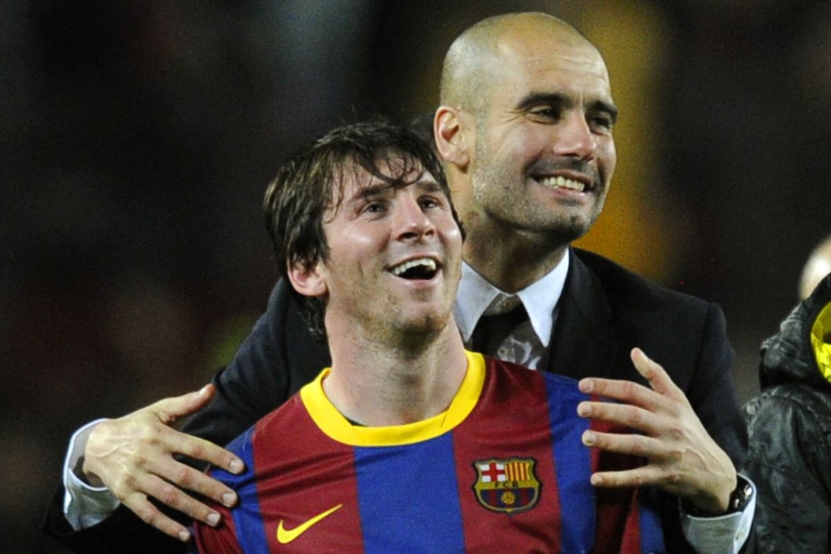 Barcelona's coach Josep Guardiola (R) celebrates with Barcelona's Argentinian forward Lionel Messi after  the Champions League semi-final second leg football match between Barcelona and Real Madrid at the Camp Nou stadium in Barcelona on May 3, 2011. Barcelona qualified for the Champions League final after drawing 1-1 in their semi-final second leg clash with bitter rivals Real Madrid to progress 3-1 on aggregate.  AFP PHOTO/JAVIER SORIANO (Photo by JAVIER SORIANO / AFP)