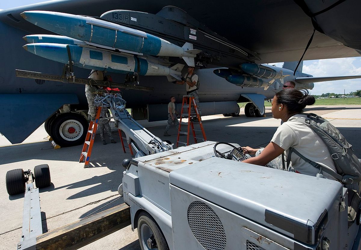 Members of the Global Strike Challenge nuclear/conventional load crew team lift a GBU-31 Joint Direct Attack Munition into position during a dry run leading up to the 2012 Air Force Global Strike Command Challenge on Barksdale Air Force Base, La., Aug. 20, 2012. (U.S. Air Force photo/Staff Sgt. Chad Warren)