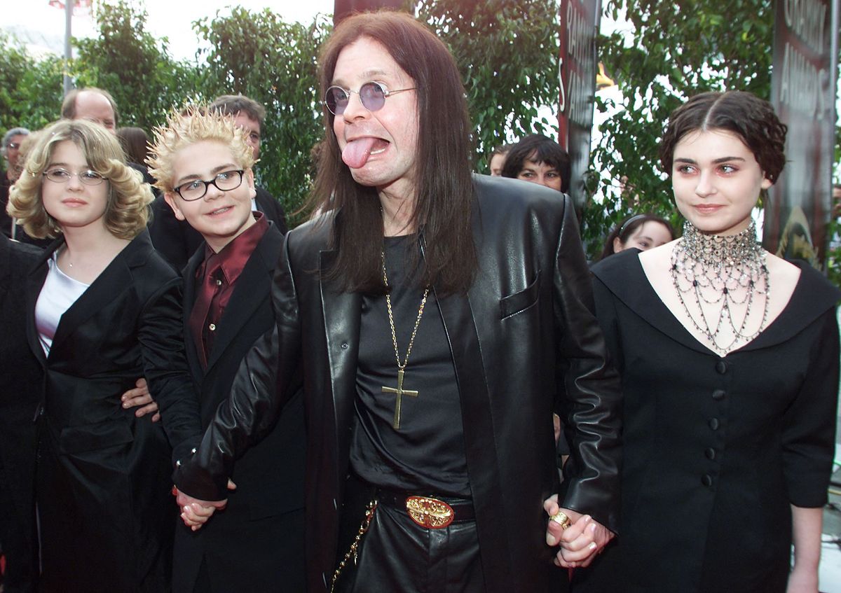 British Metal Artist Ozzy Osbourne (C) arrives at the 42nd Grammy Awards Ceremony with his family in Los Angeles, CA, 23 February, 2000. Osbourne's group "Black Sabbath" won a Grammy for Best Metal Performance for the song "Iron Man" on the album "Reunion". (ELECTRONIC IMAGE) AFP PHOTO/Lucy NICHOLSON/ln (Photo by LUCY NICHOLSON / AFP)