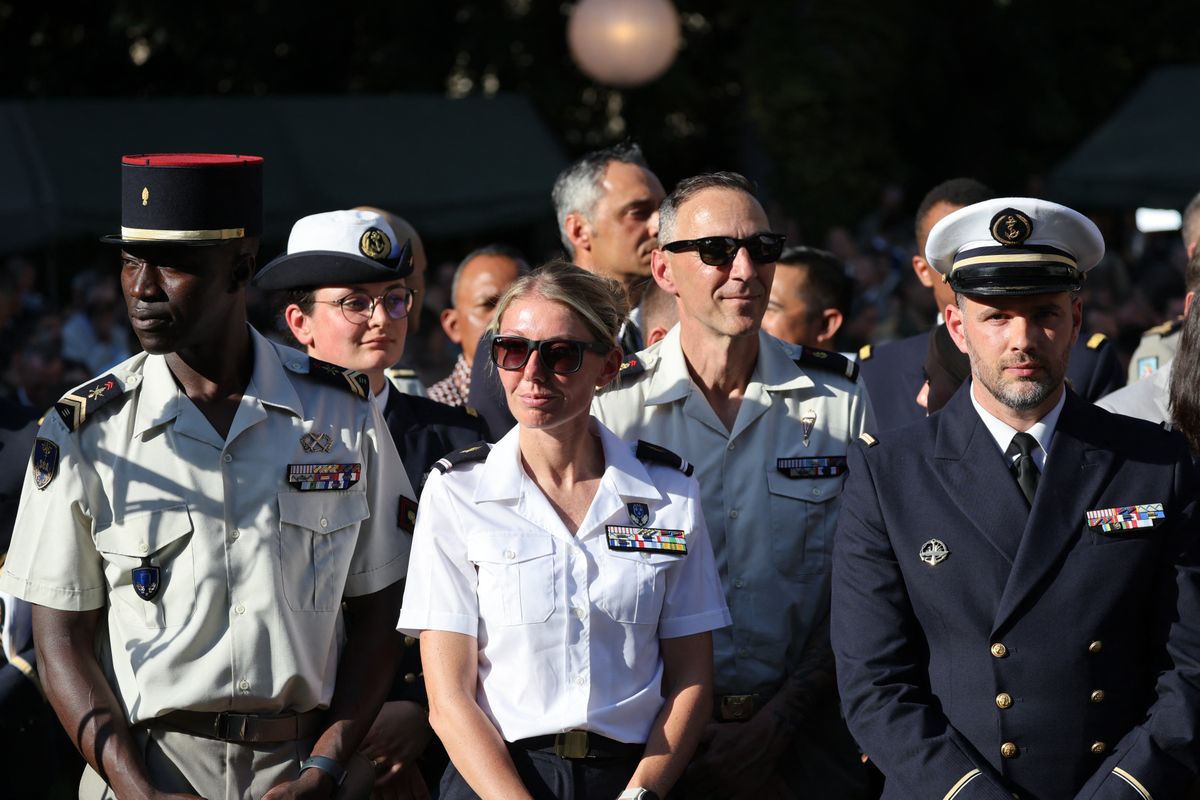 Members of the French military stand among other officials before the French president addresses army leaders at lHôtel de Brienne in Paris on July 13, 2025, on the eve of the annual Bastille Day Parade in the French capital. (Photo by Ludovic MARIN / POOL / AFP)