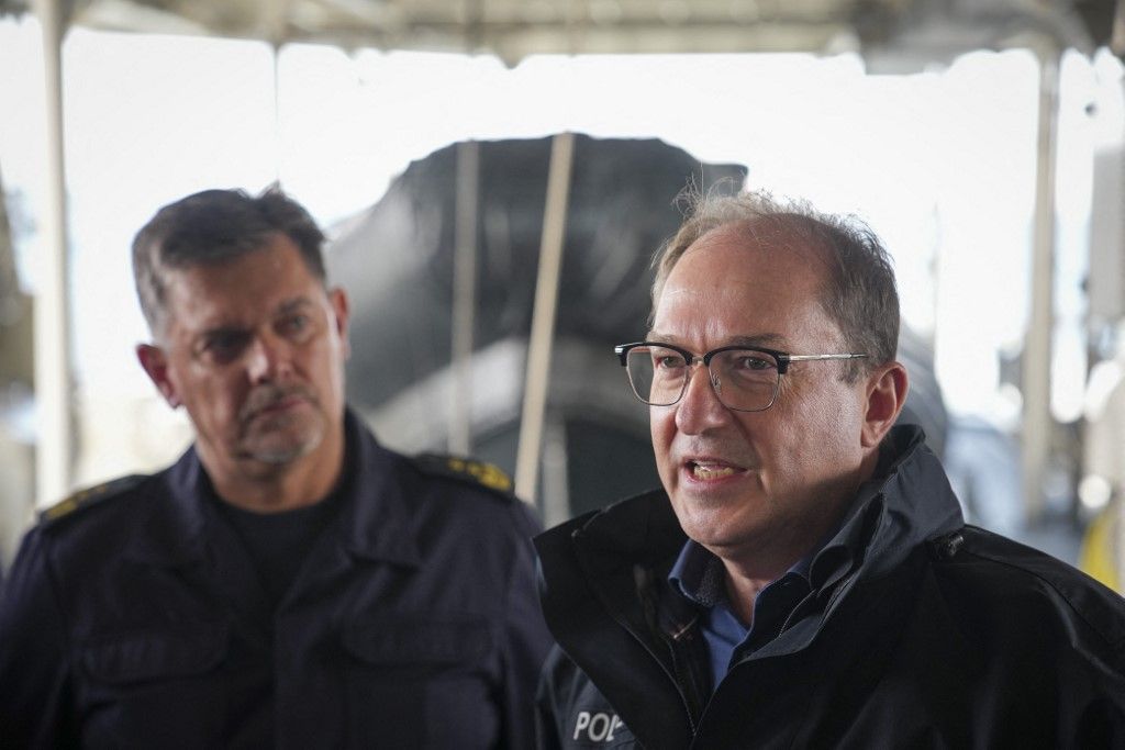 14 July 2025, Schleswig-Holstein, Neustadt in Holstein: Alexander Dobrindt (CSU, r), Federal Minister of the Interior, and Normen Großmann, President of the Bad Bramstedt Federal Police Directorate, during a statement on board the BP 84 "Neustadt". During a visit to the Federal Police Directorate Bad Bramstedt, Federal Police Sea Directorate, Dobrindt learns about the operational capabilities of the maritime forces of the Federal Police on board the BP 84 "Neustadt" during an operational trip. Photo: Christian Charisius/dpa (Photo by CHRISTIAN CHARISIUS / dpa Picture-Alliance via AFP)