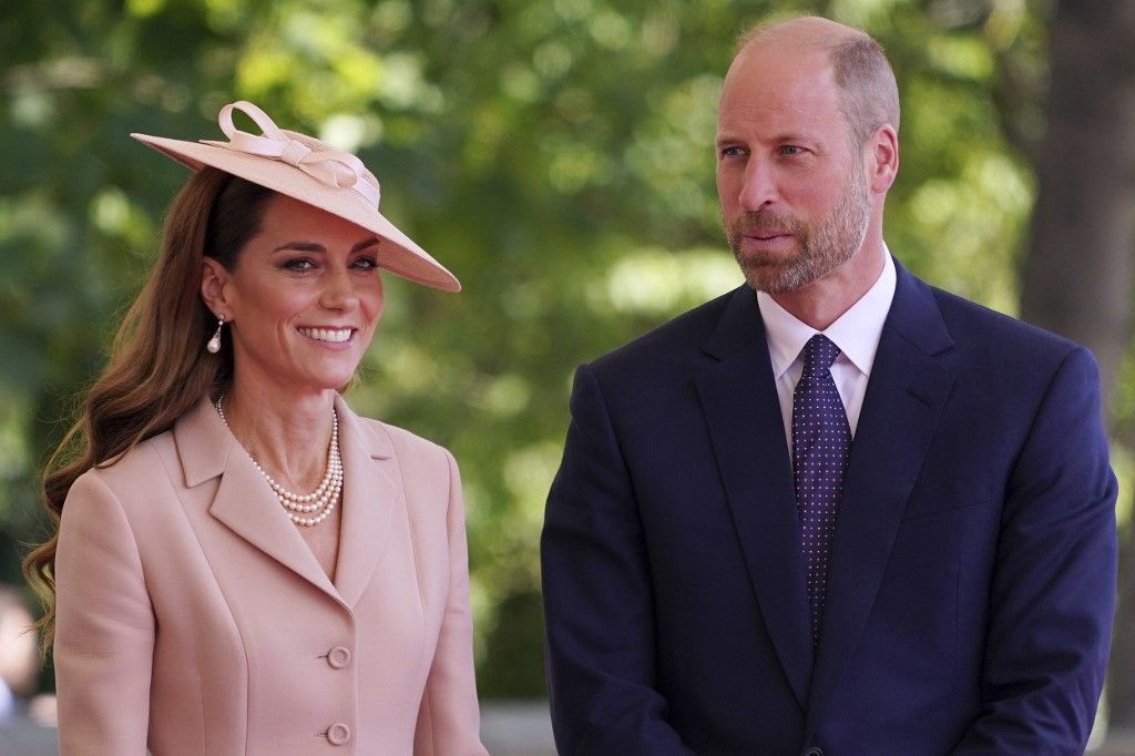 Britain's Catherine, Princess of Wales and Britain's Prince William, Prince of Wales react during a ceremonial welcome at Windsor Castle, in Windsor west of London, on July 8, 2025, on the first day of a three-day state visit to Britain for France's President Emmanuel Macron. French President Emmanuel Macron began a three-day state visit to Britain on Tuesday, which will see him address parliament and try to rekindle a purportedly warm relationship with King Charles III. (Photo by Alberto Pezzali / POOL / AFP)