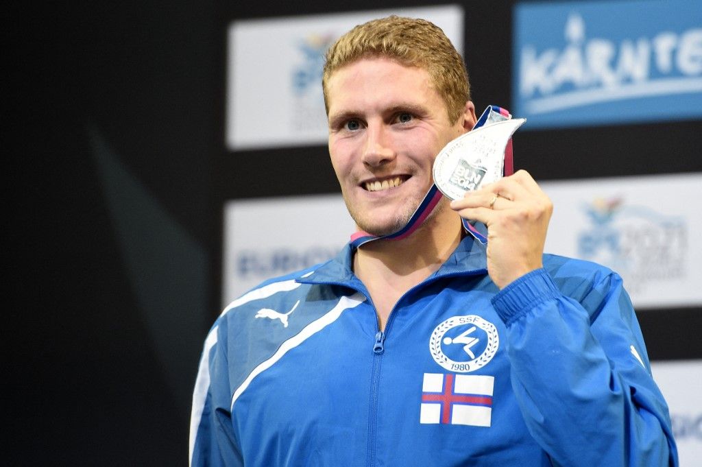 Second placed Faroe Island's Pal Joensen celebrates on the podium after the men's 800m Freestyle final of the 32nd LEN European Swimming Championships on August 22, 2014 in Berlin.    
AFP PHOTO / DAMIEN MEYER (Photo by DAMIEN MEYER / AFP)
