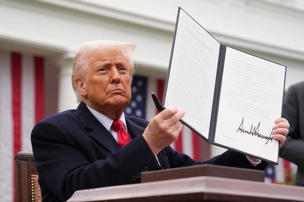 (FILES) U.S. President Donald Trump displays a signed executive order imposing tariffs on imported goods during a Make America Wealthy Again trade announcement event in the Rose Garden at the White House in Washington, DC, on April 2, 2025. Indian exporters are anxiously eyeing the possible reintroduction of Donald Trump's punishing tariffs on the second week of July 2025, though many hold out hope for a last-minute reprieve. The US president's April 2 "Liberation Day" announcement of swingeing levies on dozens of key trading partners sent shockwaves through capitals before he announced a pause for negotiations, which ends on July 9, 2025. New Delhi and Washington have been locked in multiple rounds of talks, with hopes for an interim pact to avert the 26 percent "reciprocal" tolls meted out to India. (Photo by Andrew Harnik / GETTY IMAGES NORTH AMERICA / AFP)