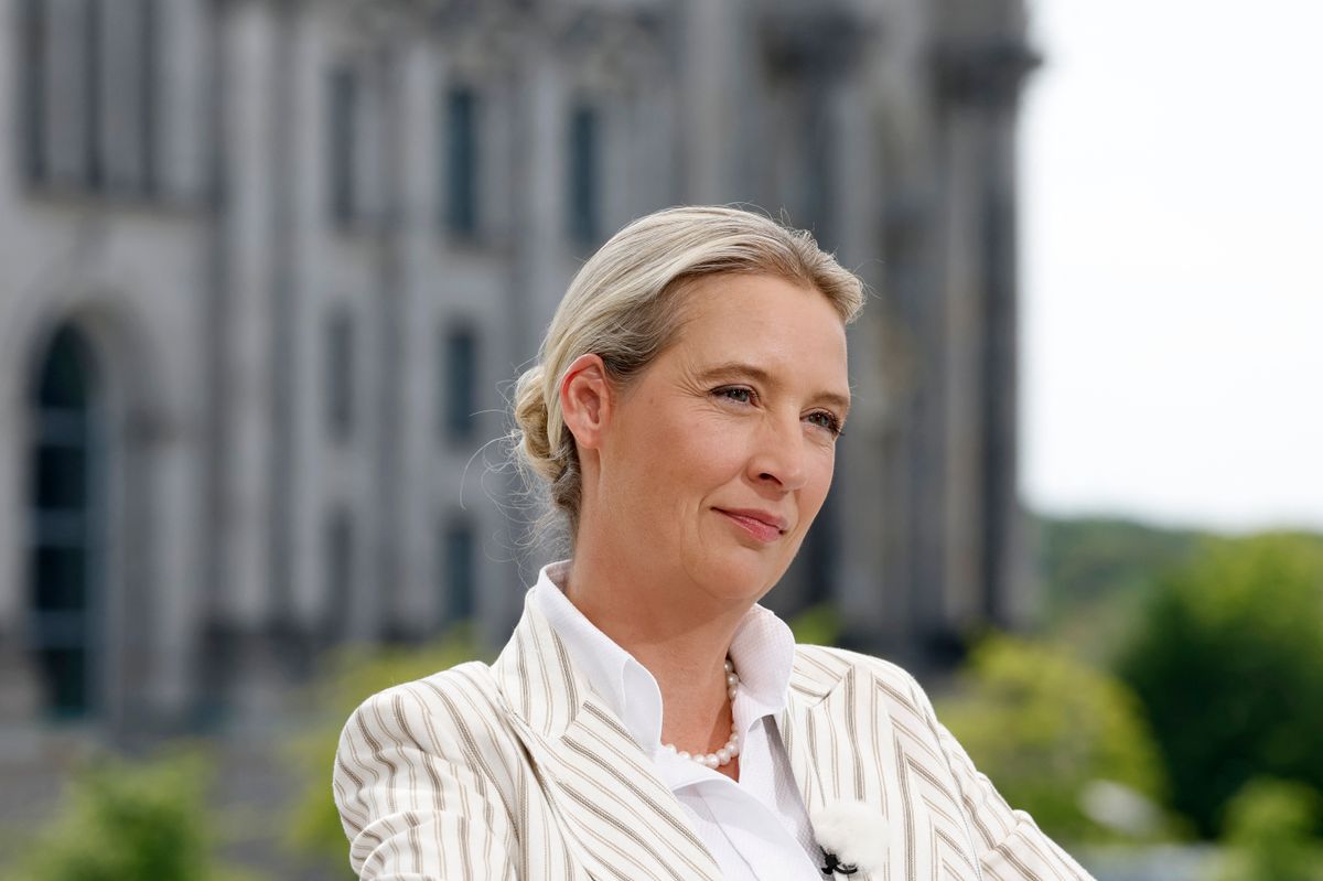 Co-leader of the far-right Alternative for Germany (AfD) party Alice Weidel looks on prior to a summer interview with German public broadcaster ARD in Berlin's government quarter, as the Reichstag building is seen in the background, on July 20, 2025. (Photo by Odd ANDERSEN / AFP)