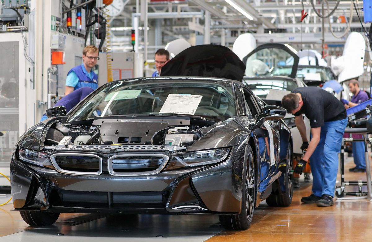 20 May 2019, Saxony, Leipzig: Employees at the BMW plant in Leipzig assemble an electrically driven i8. Federal President Steinmeier visited the plant on a company action day in Europe. He spoke in front of about 2500 employees and promoted a high turnout in the upcoming European elections... Photo: Jan Woitas/dpa-Zentralbild/dpa (Photo by JAN WOITAS / dpa-Zentralbild / dpa Picture-Alliance via AFP)