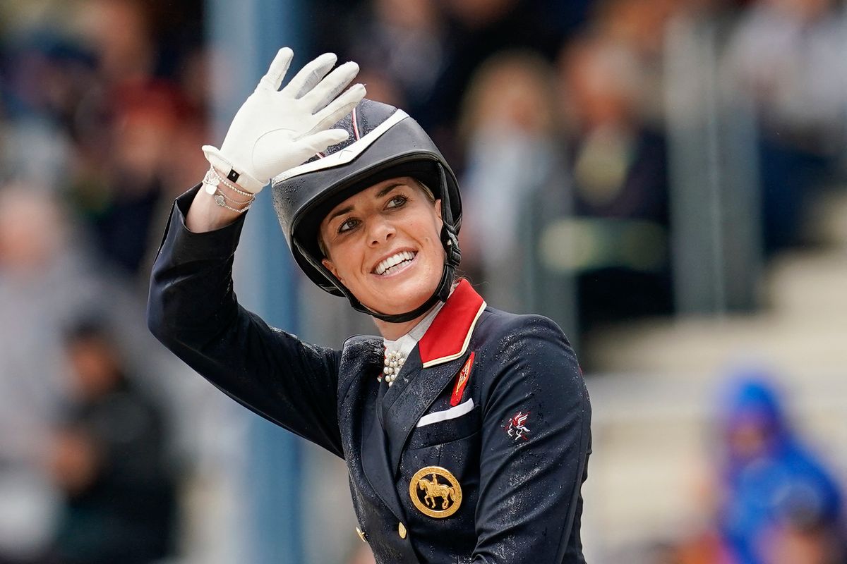01 July 2023, North Rhine-Westphalia, Aachen: Equestrian sport, dressage: CHIO, Grand Prix Special (2nd Nations' Cup competition). Charlotte Dujardin from Great Britain on the horse "Imhotep" waves. Photo: Uwe Anspach/dpa (Photo by UWE ANSPACH / dpa Picture-Alliance via AFP)