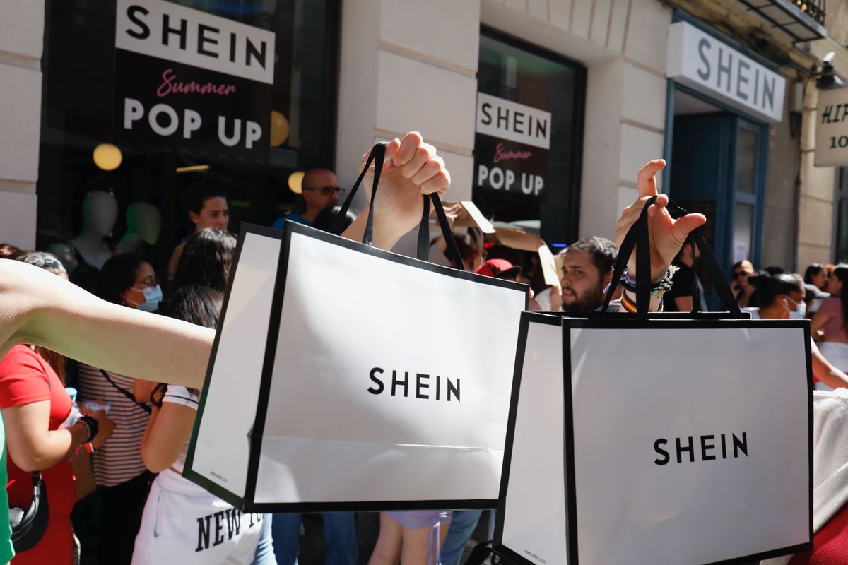 shein, LugasMADRID, SPAIN - JUNE 02: Two people hold two Shein bags after entering SHEIN's first physical store in Madrid, June 2, 2022, in Madrid, Spain. Chinese 'online' fashion brand Shein opens its first 'pop up store' in Madrid following the good reception of recent similar openings in countries such as France, Mexico and the United States. The store opens its doors today and will be open until June 5, where customers will be able to shop for women's and men's fashion collections. (Photo By Cezaro De Luca/Europa Press via Getty Images)