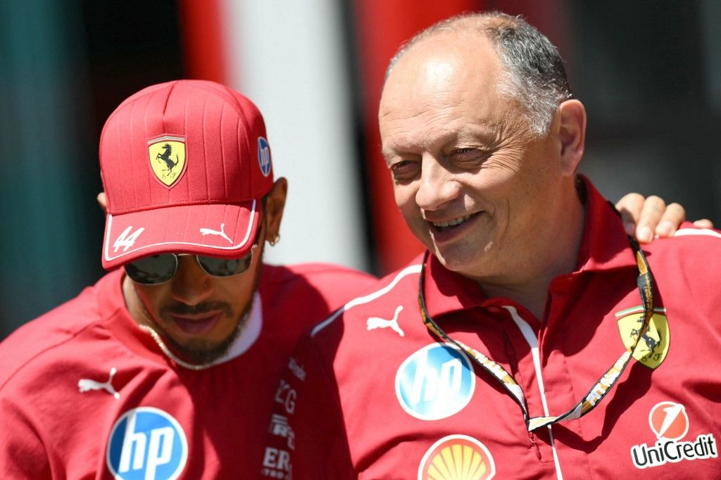 Ferrari's British driver Lewis Hamilton (L) and Ferrari's French team principal Frederic Vasseur speak ahead of the first practice session for the 2025 Emilia Romagna Formula One Grand Prix at the Imola autodrome in Imola, on May 16, 2025. (Photo by Marco BERTORELLO / AFP)