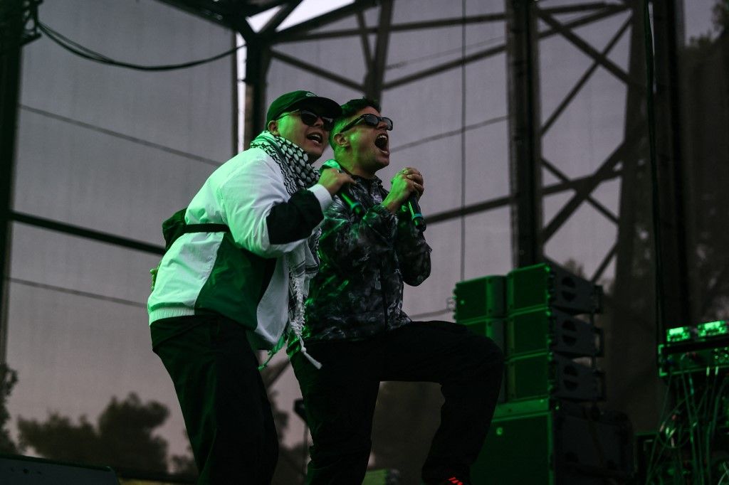 Mo Chara and Móglai Bap of Irish group Kneecap perform on stage during Rockwave Festival, in Athens, Greece, on July 13, 2025. The member of the group Mo Chara  was charged with a terror offence in May and appeared at Westminster Magistrates' Court earlier this month. (Photo by Dimitris Kapantais / SOOC via AFP)