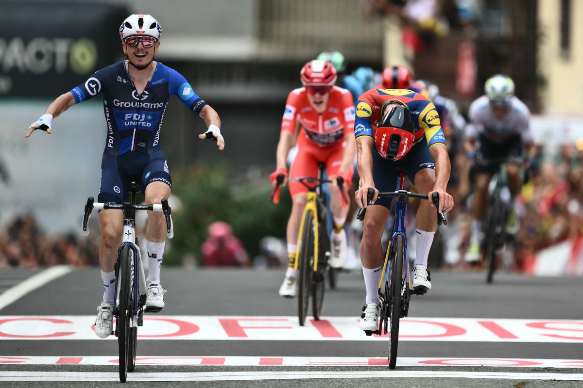 Team Groupama-FDJ's French rider David Gaudu (L) crosses the finish line in first place ahead of Team Lidl-Trek's Danish rider Mads Pedersen during the third stage of the Vuelta a Espana, a 134 km race between San Maurizio Canavese and Ceres, in Italy's Piemonte region, on August 25, 2025. (Photo by Marco BERTORELLO / AFP)