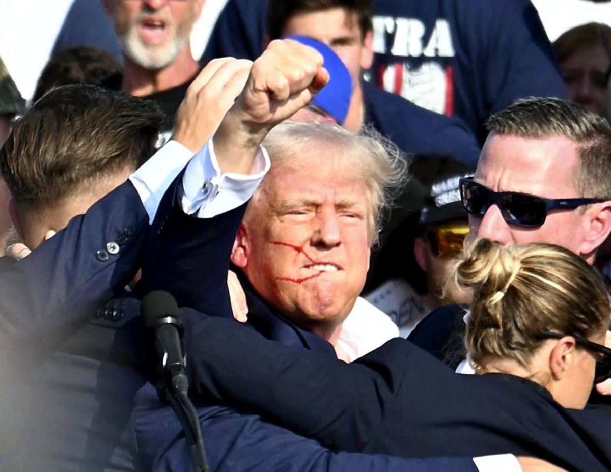 U. S. Republican presidential candidate former President Donald Trump is surrounded by U.S. Secret Service agents in Butler, Pennsylvania on July 13, 2024. The former president suffered a gunshot wound to his ear after a suspect fired gunshots at his Pennsylvania rally and he survived the assassination attempt. According to the law official, the suspected shooter was killed by the Secret Service. ( The Yomiuri Shimbun ) (Photo by Takayuki Fuchigami / The Yomiuri Shimbun via AFP)