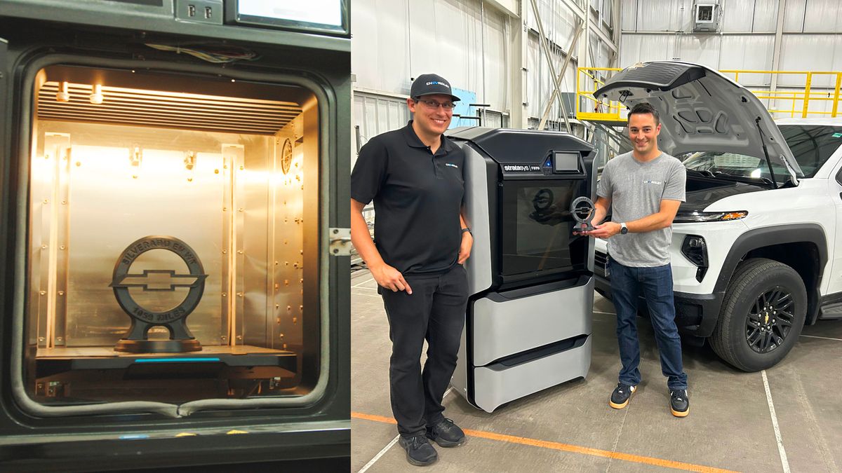 Daniel Gay (left) and Jon Doremus, engineers who participated in the Silverado EV range record attempt, with the 3D-printed trophy commemorating this achievement.