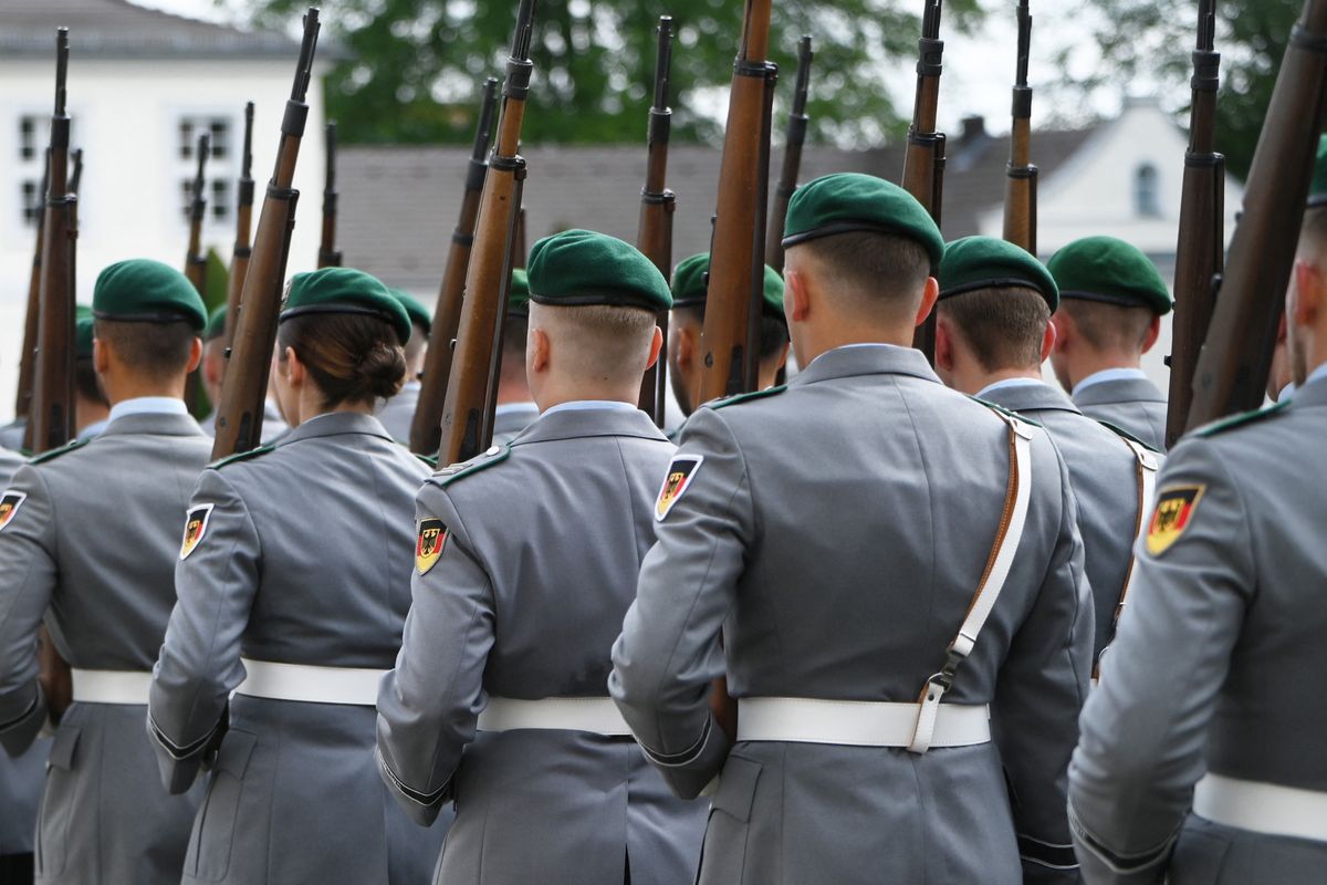 22 July 2025, Berlin: Bundeswehr soldiers march during a military ceremony in front of Bellevue Palace in Berlin. The occasion is the accreditation of new ambassadors. The uniformed soldiers wear gray service uniforms with a green beret, white belt and carry rifles over their shoulders. Photo: Malin Wunderlich/dpa (Photo by Malin Wunderlich / dpa Picture-Alliance via AFP)