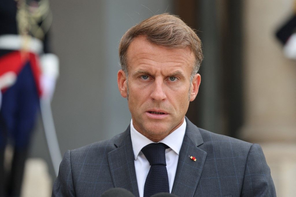France's President Emmanuel Macron speaks as he greets Ukraine's President prior to their meeting, at The Elysee Presidential Palace in Paris on September 3, 2025. A so-called Coalition of the Willing, counting some 30 countries, intends to provide support to Ukraine's military and possibly deploy some of its own soldiers to Ukraine when and if a ceasefire is agreed. The deployment would aim to deter future Russian aggression. (Photo by Ludovic MARIN / AFP)