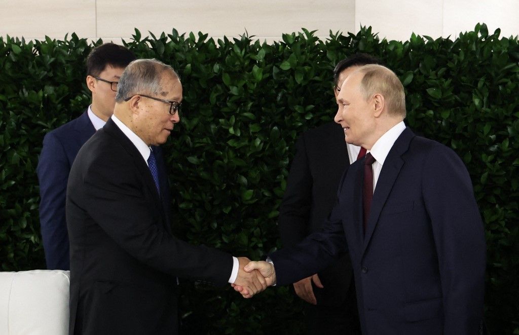 In this pool photograph distributed by the Russian state agency Sputnik, Russia's President Vladimir Putin shakes hands with Li Hongzhong, First Vice Chairman of the Standing Committee of the National People's Congress (NPC) prior to the plenary session of the Eastern Economic Forum in Vladivostok on September 5, 2025. (Photo by Alexander KAZAKOV / POOL / AFP)