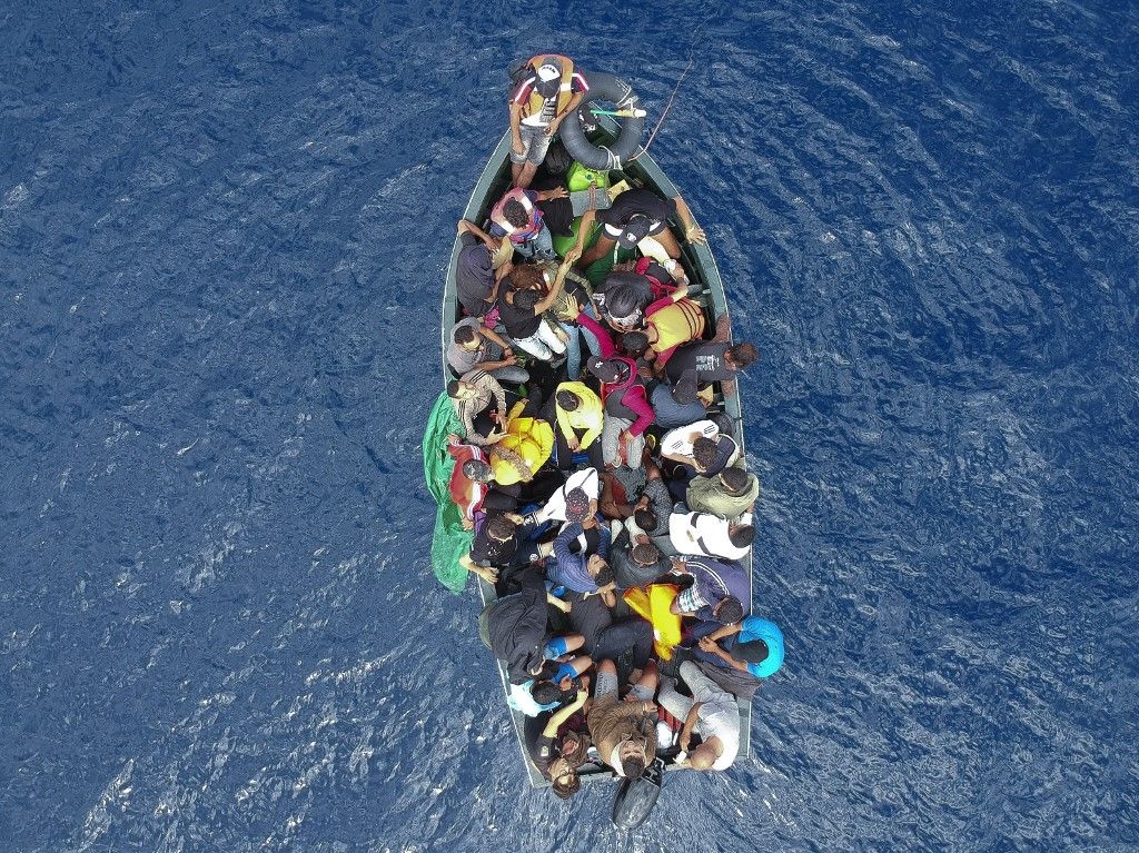 An aerial photo shows a boat carrying migrants stranded in the Strait of Gibraltar before being rescued by the Spanish Guardia Civil and the Salvamento Maritimo sea search and rescue agency that saw 157 migrants rescued on September 8, 2018. While the overall number of migrants reaching Europe by sea is down from a peak in 2015, Spain has seen a steady increase in arrivals this year and has overtaken Italy as the preferred destination for people desperate to reach the continent. Over 33,000 migrants have arrived in Spain by sea and land so far this year, and 329 have died in the attempt, according to the International Organization for Migration. (Photo by Marcos Moreno / AFP)