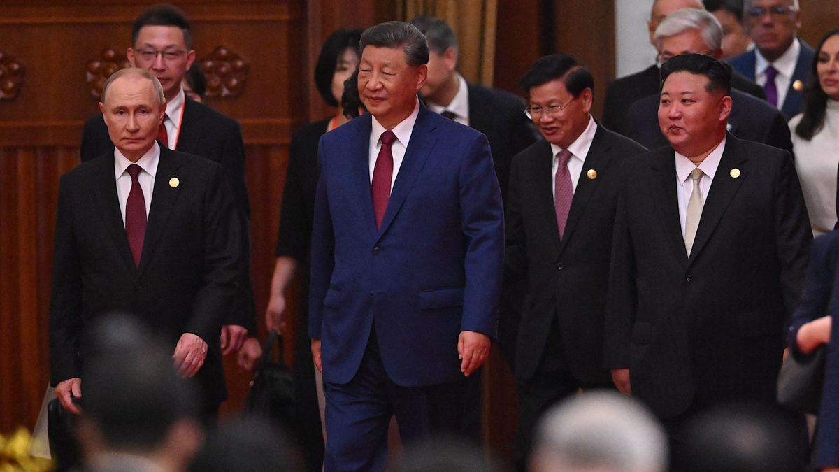 Chinas President Xi Jinping (C), North Koreas leader Kim Jong Un (R) and Russias President Vladimir Putin (L) arrive for a reception in the Great Hall of the People, following a military parade marking the 80th anniversary of victory over Japan and the end of World War II, in Beijing on September 3, 2025. (Photo by Jade Gao / AFP)