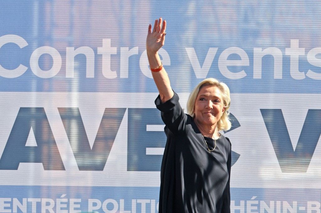Marine Le President of Rassemblement National parliamentary group Marine Le Pen waves at the audience as she arrives to deliver a speech during a meeting marking the start of the political year in Henin-Beaumont, northern France, on September 7, 2025. (Photo by FRANCOIS LO PRESTI / AFP)