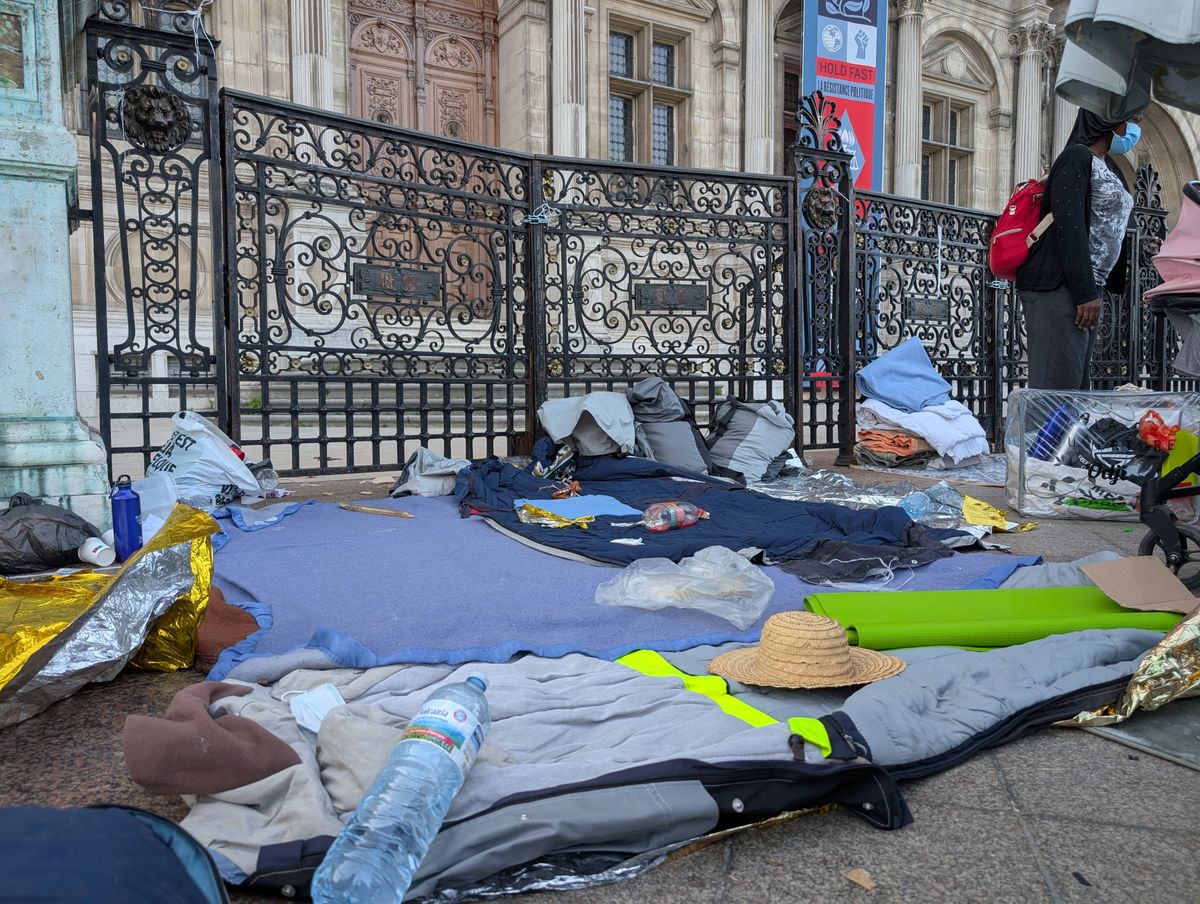 PARIS, FRANCE - AUGUST 12: French police evacuates a 250-person migrant camp set up by Utopia 56 association to request accommodation outside the Paris City Hall in Paris, France on August 12, 2025. Police cited the heatwave and health risks as reasons for the evacuation. The migrants were transferred by bus to accommodation centers in the regions, including Marseille, Bourges and Besancon. Luc Auffret / Anadolu (Photo by Luc Auffret / Anadolu via AFP)