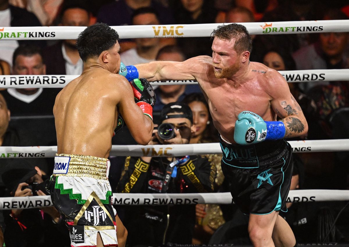 LAS VEGAS, NEVADA - MAY 04: Saul 'Canelo' Alvarez (in black & turquoise short) from Guadalajara, Mexico and Jaime Munguia (in gold & white short) from Tijuana, Mexico exchange punches during their super middleweight undisputed world titles of the Premiere Boxing Championship on Saturday night at the T-Mobile Arena in Las Vegas, Nevada, United States on May 04, 2024. Tayfun Coskun / Anadolu (Photo by Tayfun Coskun / Anadolu via AFP)