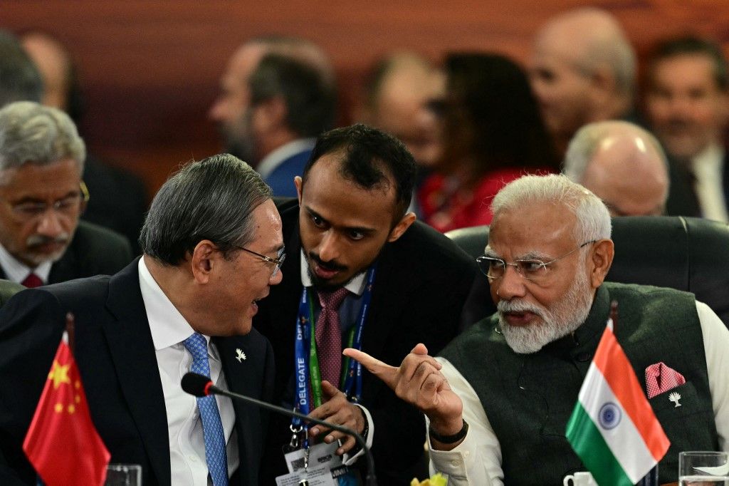 China's Premier Li Qiang (L) talks with India's Prime Minister Narendra Modi (R) during a plenary session of the BRICS summit in Rio de Janeiro, Brazil, on July 7, 2025. BRICS leaders at a summit on Sunday took aim at US President Donald Trump's "indiscriminate" import tariffs and recent Israeli-US strikes on Iran. (Photo by Pablo PORCIUNCULA / AFP)