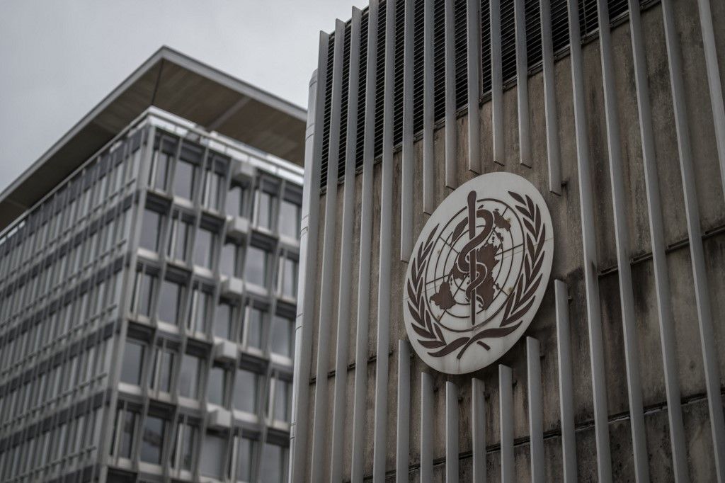 This photograph shows a logo of the World Health Organisation (WHO) displayed on the facade of organisation's headquarters in Geneva on April 23, 2025. The Director-General of the WHO said on April 22, 2025, that US budget cuts were leaving the UN agency's accounts in the red, forcing it to reduce its operations and lay off staff. (Photo by Fabrice COFFRINI / AFP)