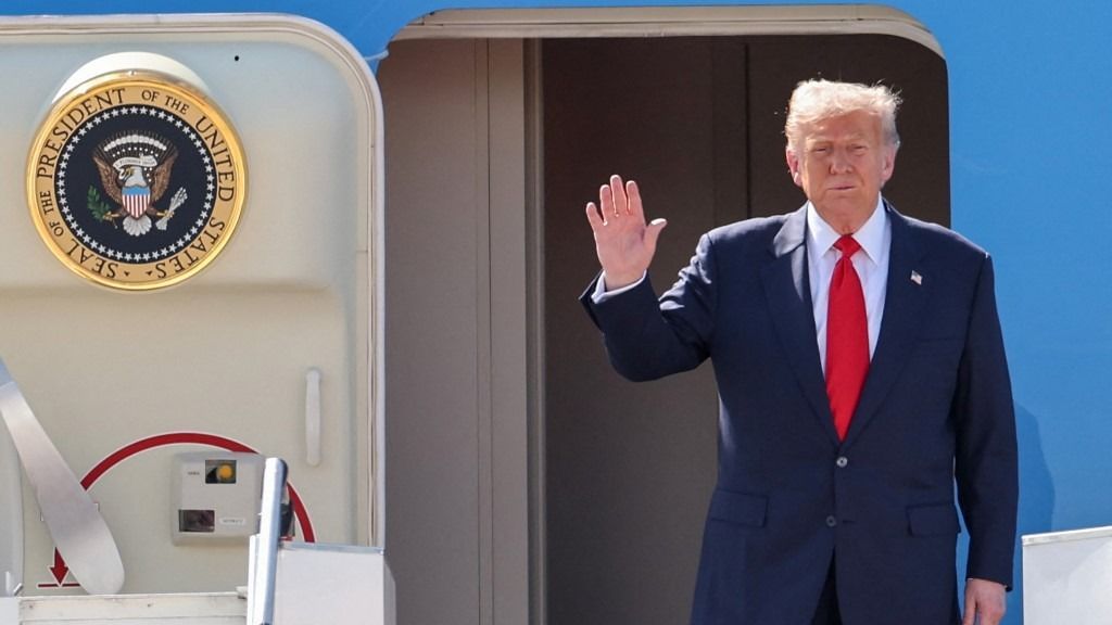 US President Donald Trump waves at the top of the stairs of Air Force One as he arrives at Kuala Lumpur International Airport in Sepang on October 26, 2025. US President Donald Trump arrived in Malaysia on October 26 on the first leg of an Asian tour that will include high-stakes trade talks with Chinese counterpart Xi Jinping. (Photo by Hasnoor Hussain / POOL / AFP)