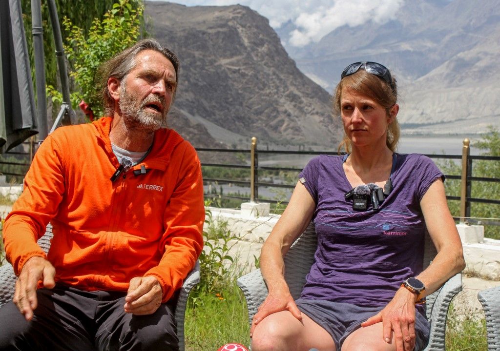 Marina Eva (R), mountaineering partner of German Olympic biathlon champion Laura Dahlmeier, looks on as rescue team member Thomos Huber (L) speaks during a press conference in Skardu in Pakistan's mountainous Gilgit-Baltistan region on July 31, 2025. Germany's two-time Olympic biathlon gold medallist Laura Dahlmeier was confirmed dead at age 31 on July 30, after being hit by falling rocks on a Pakistani mountain. (Photo by Manzoor BALTI / AFP)