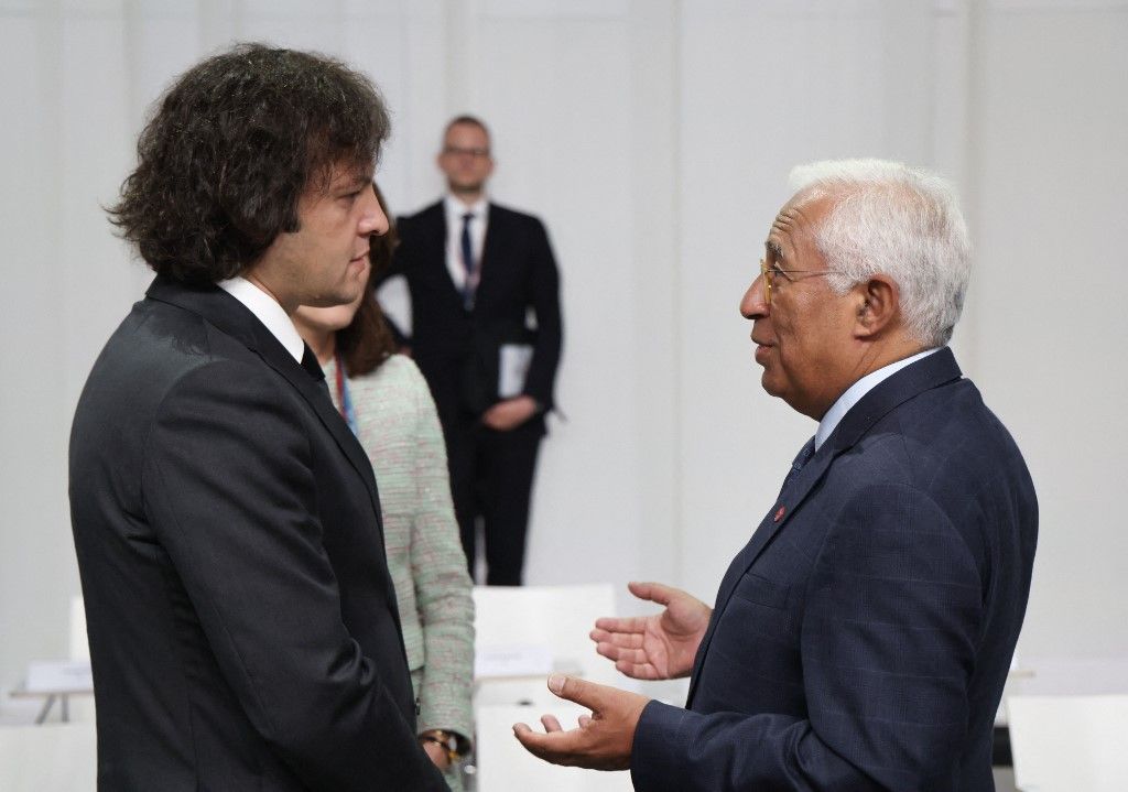 Georgia's Prime Minister Irakli Kobakhidze talks with European Council President Antonio Costa (R) at the start of the plenary session of the 7th European Political Community (EPC) Summit at the Bella Center in Copenhagen on October 2, 2025. (Photo by Ludovic MARIN / AFP)