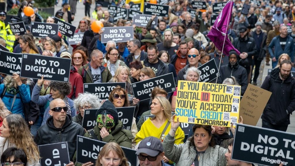 LONDON, UNITED KINGDOM - OCTOBER 18:  Protesters march against UK Government’s plan to introduce a digital identification card in central in London, United Kingdom on October 18, 2025. The government wants to introduce a digital ID system across the UK, with Prime Minister Sir Keir Starmer saying it will ensure the country's 'borders are more secure'. The IDs will not have to be carried day-to-day, but they will be compulsory for anyone wanting to work. Ilyas Tayfun Salci / Anadolu (Photo by Ilyas Tayfun Salci / Anadolu via AFP)