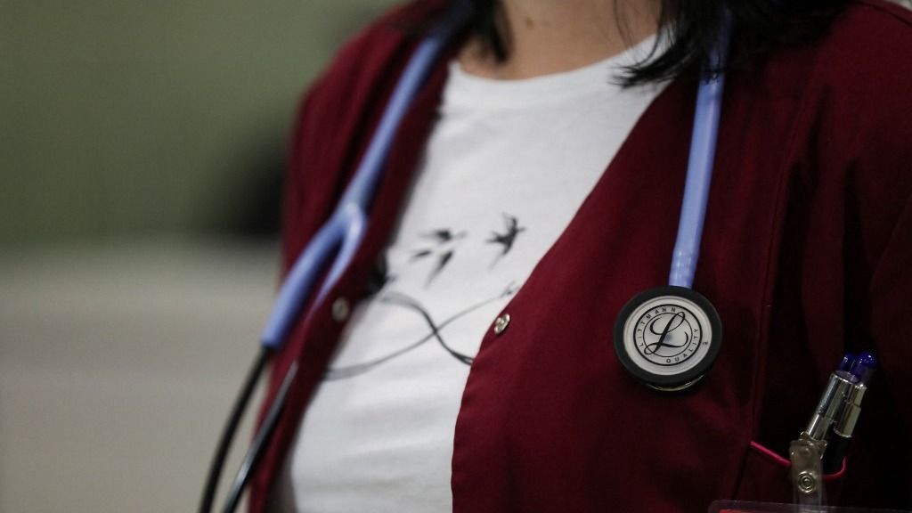 In Krakow, Poland, on October 17, 2025, a doctor with a stethoscope participates in the 'Cooperation 2025' defense exercise at the 5th Military Clinical Hospital and the SPZOZ Polyclinic. Uniformed services conduct a 'Cooperation 2025' defense and civil defense exercise in the Malopolska region from October 15-17. On the final day of the exercise, activities at the 5th Military Clinical Hospital and Polyclinic (SPZOZ) focus on practicing potential human contamination with the element SELENIUM 75. In accordance with the exercise's assumptions, no detailed scenario information is provided before the exercise begins, allowing for the testing of currently implemented procedures. (Photo by Klaudia Radecka/NurPhoto) (Photo by Klaudia Radecka / NurPhoto via AFP)