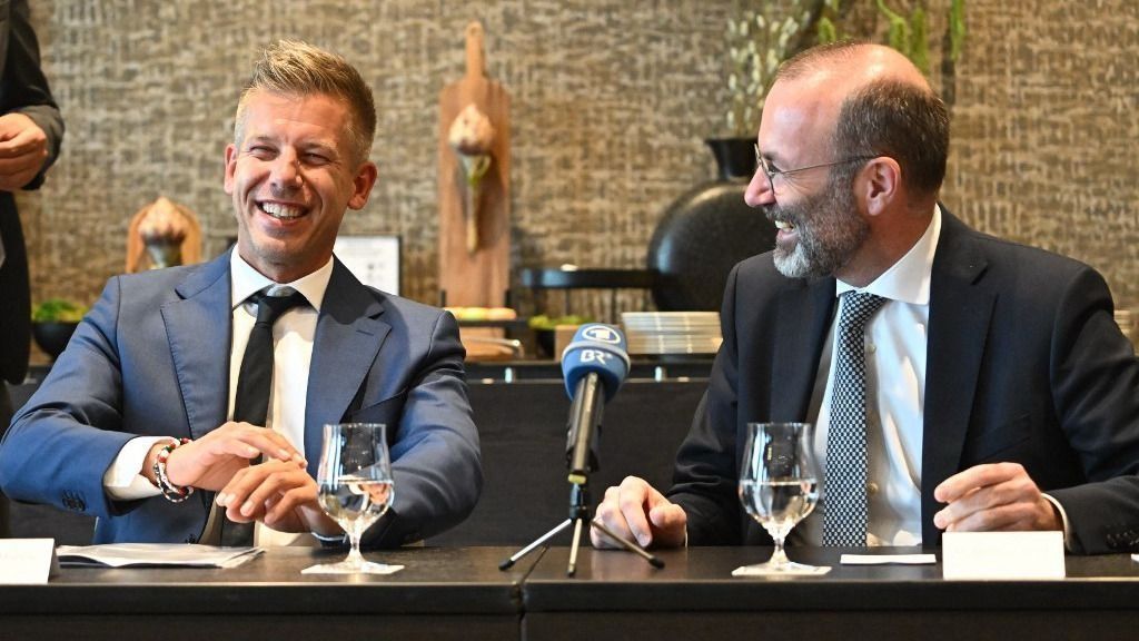 Leader of Hungarian Tisza party and former government member turned opposition leader Peter Magyar (L) and President of the centre-right European People's Party (EPP) Manfred Weber react during a meeting with local press in a Budapest's hotel Hungary on June 14, 2024. Weber arrived to Budapest about the accession of the seven elected members of the European Parliament of the Tisza party. (Photo by Attila KISBENEDEK / AFP)