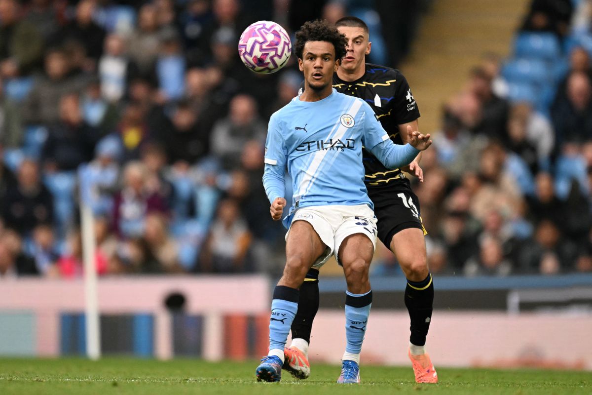 Manchester City's Norwegian midfielder #52 Oscar Bobb battles for the ball with Everton's Ukrainian defender #16 Vitaliy Mykolenko during the English Premier League football match between Manchester City and Everton at the Etihad Stadium in Manchester, north west England, on October 18, 2025. (Photo by Oli SCARFF / AFP) / RESTRICTED TO EDITORIAL USE. No use with unauthorized audio, video, data, fixture lists, club/league logos or 'live' services. Online in-match use limited to 120 images. An additional 40 images may be used in extra time. No video emulation. Social media in-match use limited to 120 images. An additional 40 images may be used in extra time. No use in betting publications, games or single club/league/player publications. /