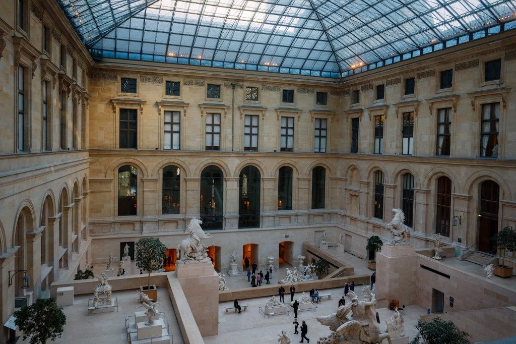 (FILES) Visitors look at statues inside the Cour Marly at the Louvre Museum in Paris on January 23, 2025. France's Culture Minister Rachida Dati on October 19, 2025 reported a theft at the Louvre in Paris, as the world-renowned museum said it was closing for the day. A robbery took place this morning at the opening of the Louvre Museum, she wrote on X. The Louvre said it was closing for the day for exceptional reasons, without providing further details on what had been stolen. (Photo by Dimitar DILKOFF / AFP) / RESTRICTED TO EDITORIAL USE - MANDATORY MENTION OF THE ARTIST UPON PUBLICATION - TO ILLUSTRATE THE EVENT AS SPECIFIED IN THE CAPTION