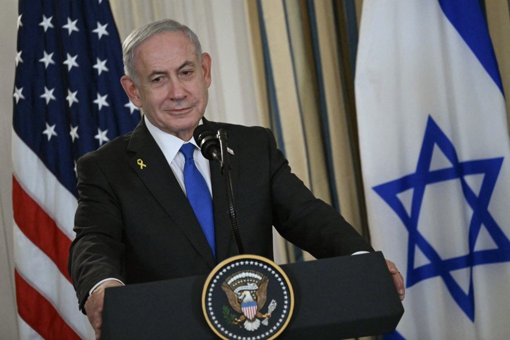 (FILES) Israeli Prime Minister Benjamin Netanyahu participates in a press conference with US President Donald Trump in the State Dining Room of the White House in Washington, DC on September 29, 2025. US President Donald Trump said on October 8, 2025 that Israel and Hamas had agreed on the first phase of his Gaza peace plan, hailing it as a "historic and unprecedented" step to ending the two-year-old war. Palestinian militant group Hamas would release all hostages while Israel would pull its troops back to an agreed on line, Trump said after talks in Egypt on his 20-point peace plan resulted in a deal. (Photo by ANDREW CABALLERO-REYNOLDS / AFP)